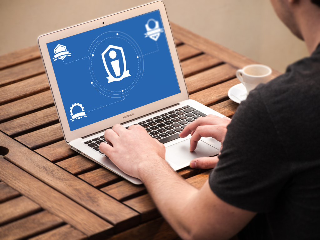 Male user in front of laptop with Credentialate on screen