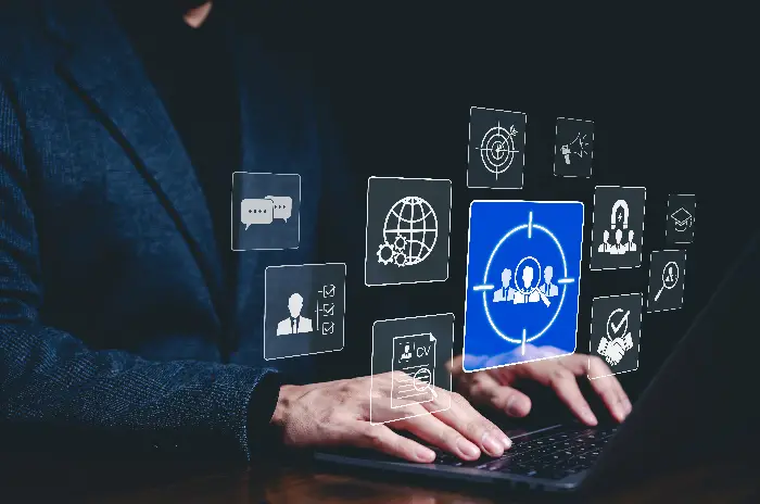 A professional using a laptop with digital icons representing recruitment, skills, and global connectivity