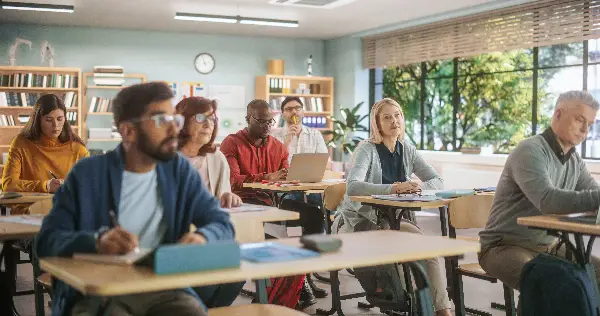 A diverse group of learners of different ages and backgrounds engaged in a community college classroom