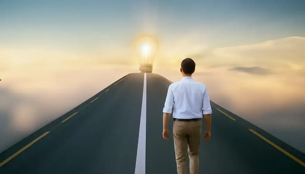 A man walks on a road illuminated by a light bulb, symbolising clear vision and opportunities ahead.